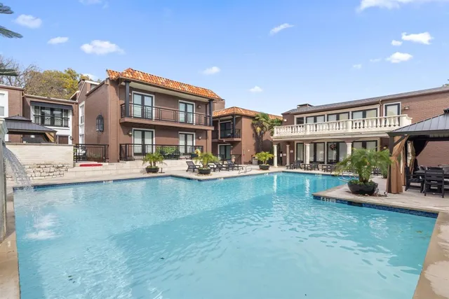 a view of a patio with a table and chairs
