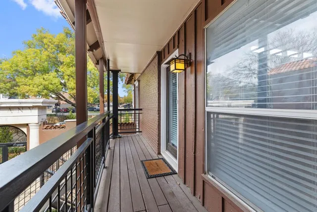 a view of balcony with wooden floor and iron stairs