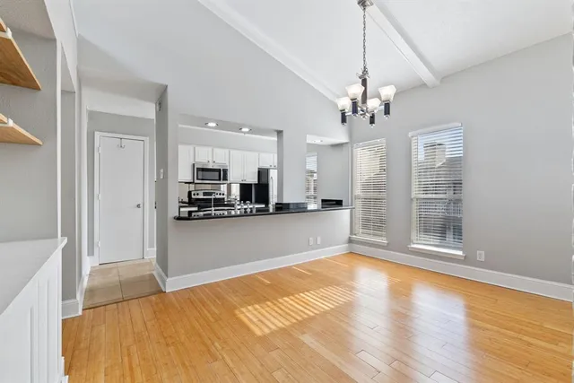 a view of a kitchen with a sink and a refrigerator