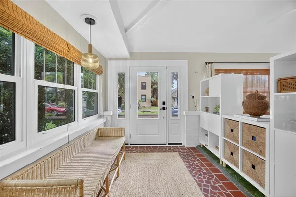 a living room with furniture a large window and a table