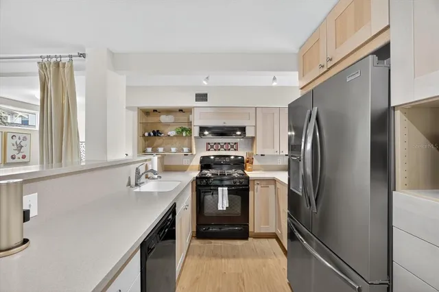 a bedroom with a bed a couch and a flat screen tv