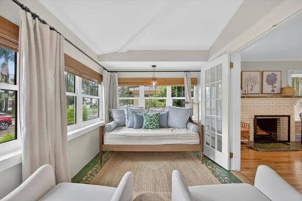 a living room with furniture a flat screen tv and a fireplace