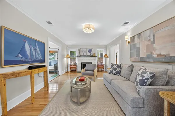 a living room with furniture and a table with wooden floor