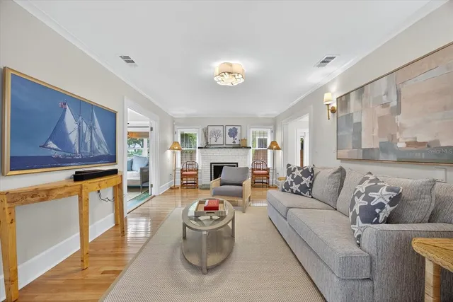 a living room with furniture and a table with wooden floor