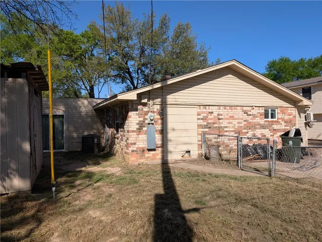 a view of a house with backyard porch and sitting area