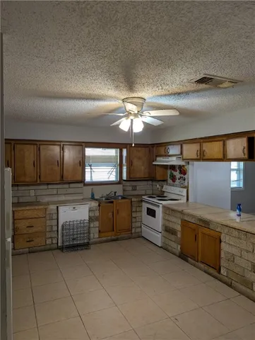 a kitchen with cabinets a sink and appliances