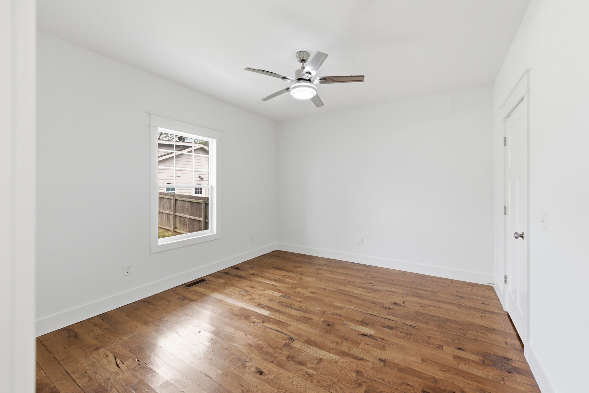 1332 B Lischey Avenue Nashville, TN 37207 - Photo 16 of 43 an empty room with wooden floor fan and windows