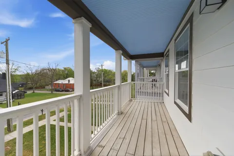 a view of a balcony with wooden floor