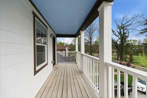a view of a balcony with wooden floor