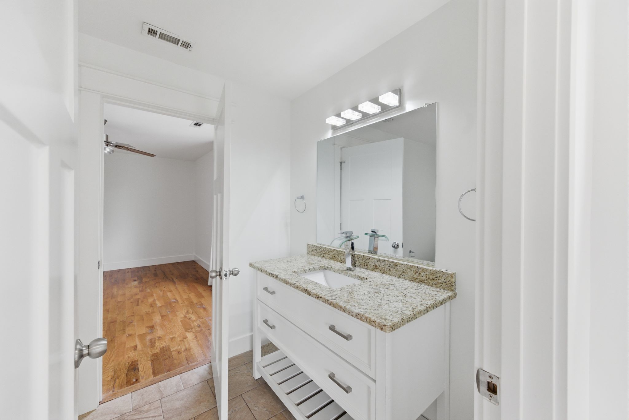 1332 B Lischey Avenue Nashville, TN 37207 - Photo 26 of 43 a bathroom with a granite countertop sink and a mirror