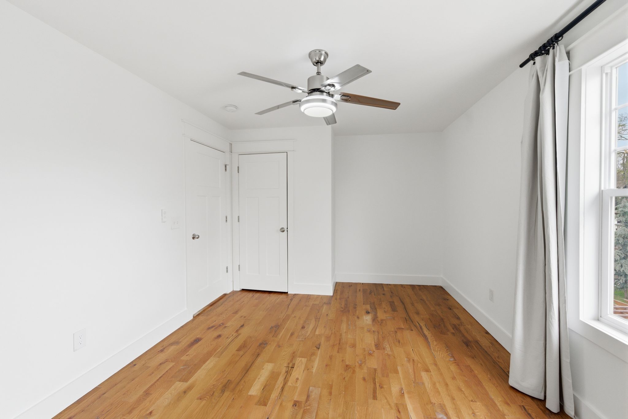 1332 B Lischey Avenue Nashville, TN 37207 - Photo 28 of 43 a view of empty room with wooden floor and fan