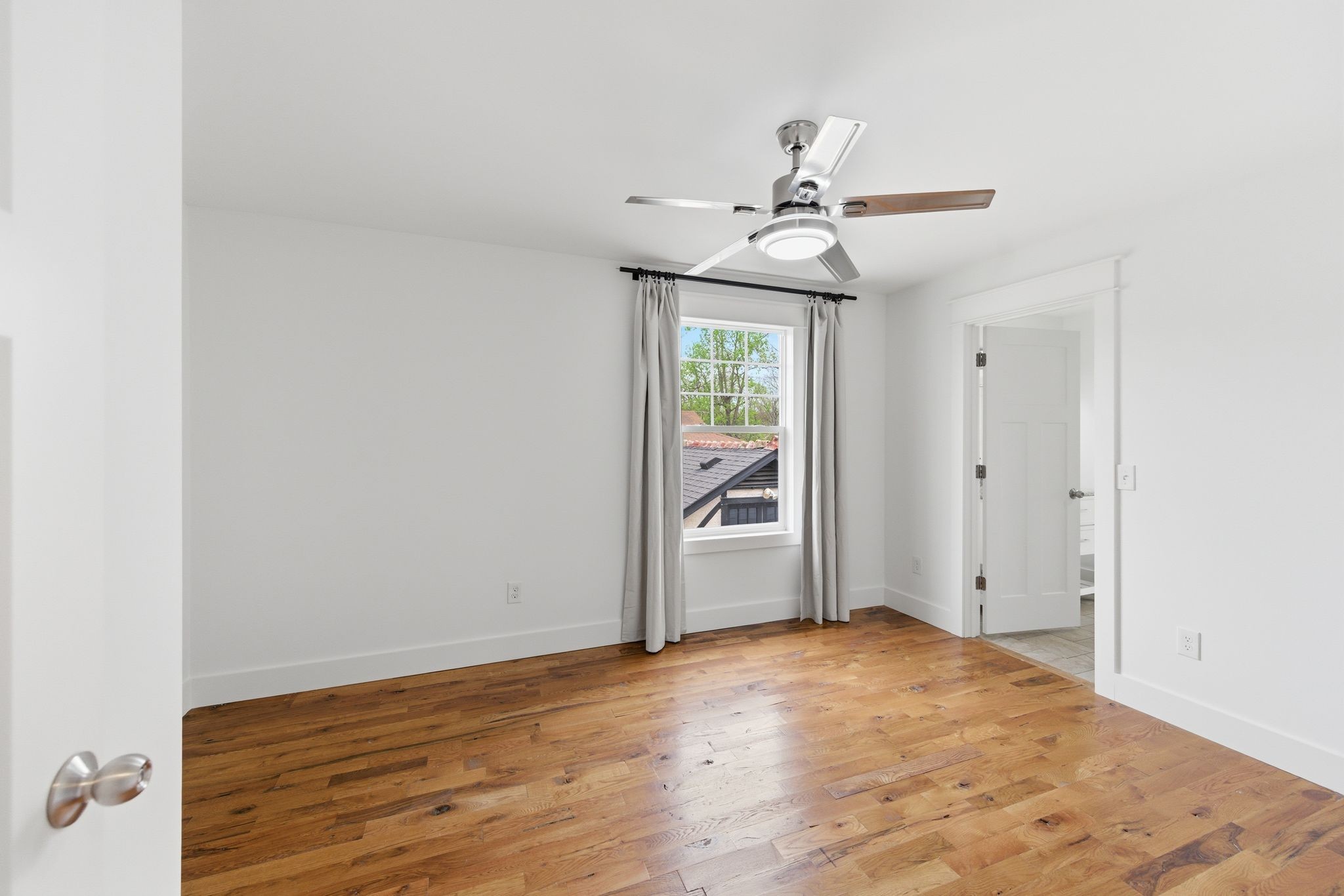1332 B Lischey Avenue Nashville, TN 37207 - Photo 29 of 43 an empty room with wooden floor fan and windows