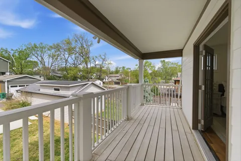 a view of a balcony with wooden floor