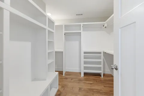 a view of walk in closet with empty racks