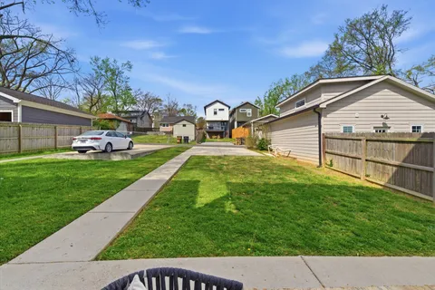 a view of a house with a yard and sitting area