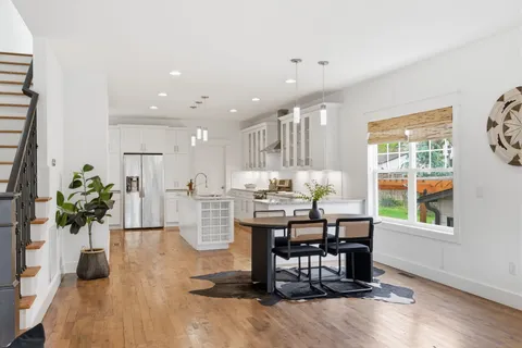a dining room with furniture and wooden floor