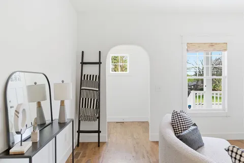 a view of staircase with wooden floor and white walls
