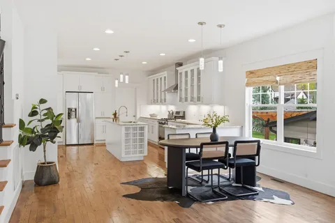 a dining room with furniture and wooden floor