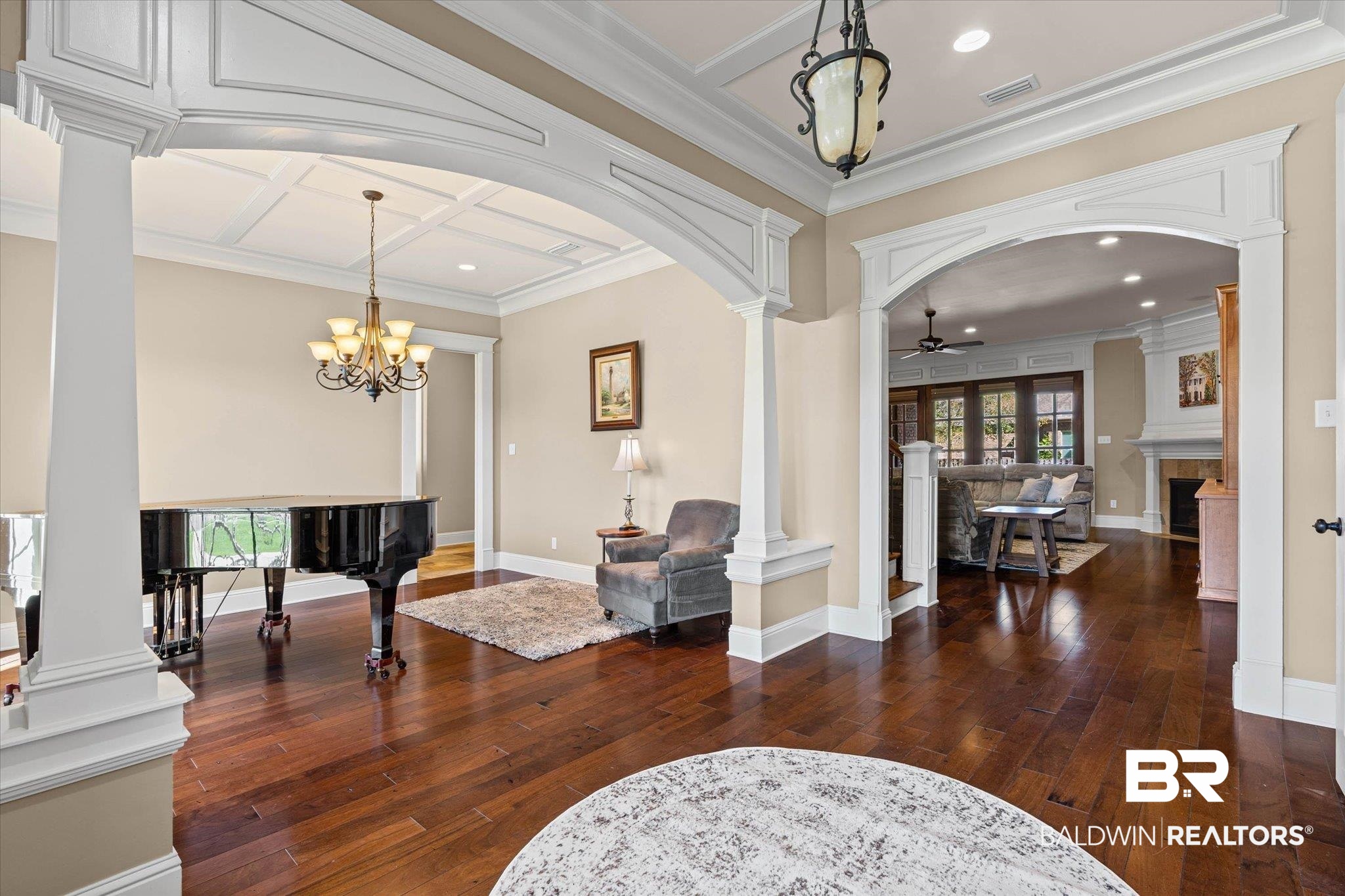7676 Rockstone Lane Mobile, AL 36695 - Photo 3 of 47 Foyer entrance featuring decorative columns, crown molding, dark wood finished floors, arched walkways, and recessed lighting