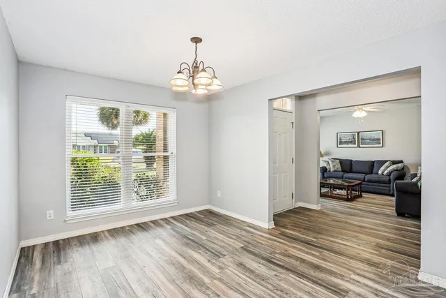a view of a livingroom with furniture wooden floor and chandelier