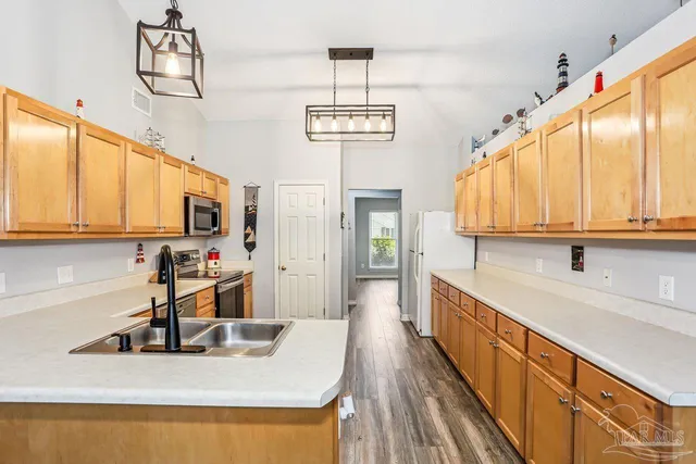 a kitchen with sink cabinets and window