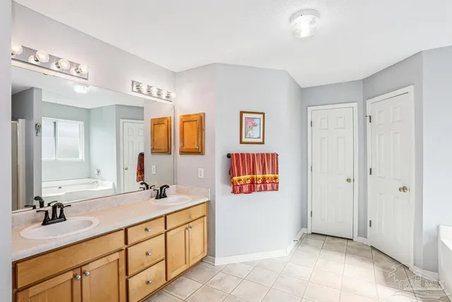 a bathroom with double sink and a mirror