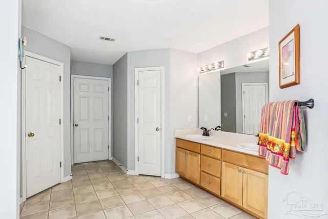 a bathroom with a sink vanity and mirror