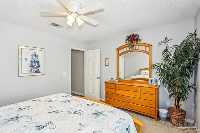 a bedroom with a bed and a dresser in it