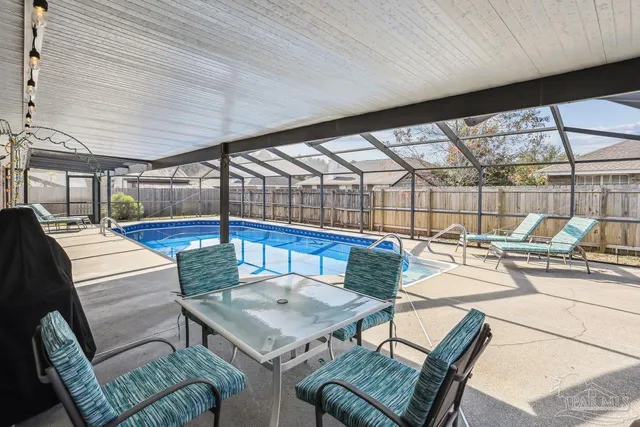 a view of a living room with a table and chairs