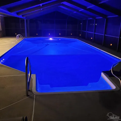 a view of a room with pool table and chandelier