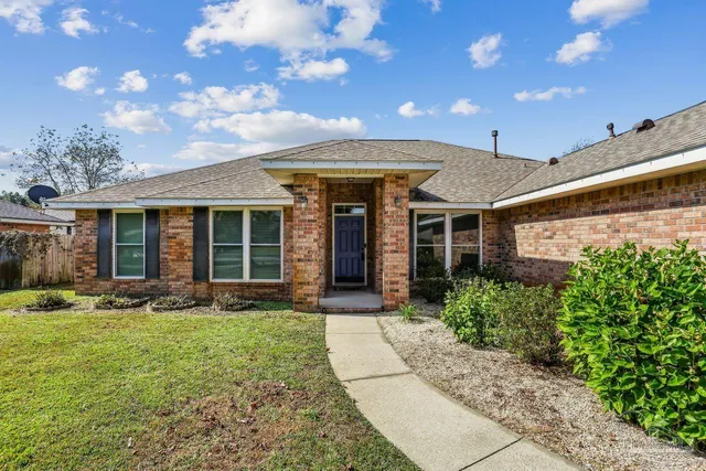 a front view of a house with garden and porch