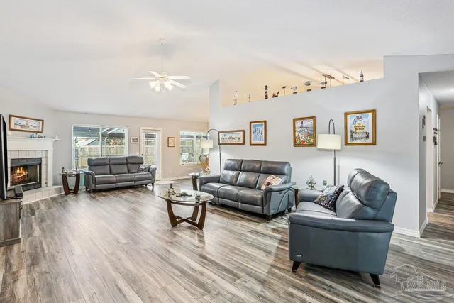 a living room with furniture and a wooden floor