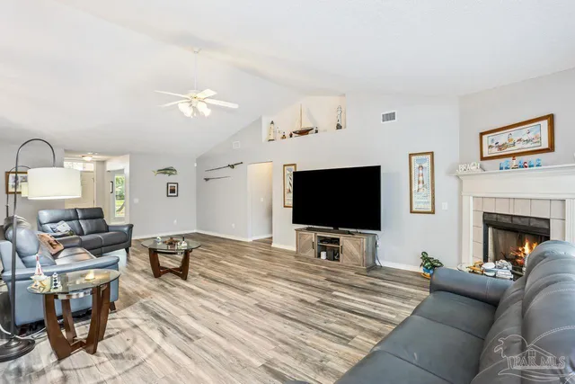 a living room with furniture and a flat screen tv