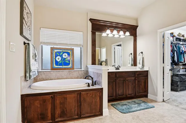 a bathroom with a sink a mirror and a shower