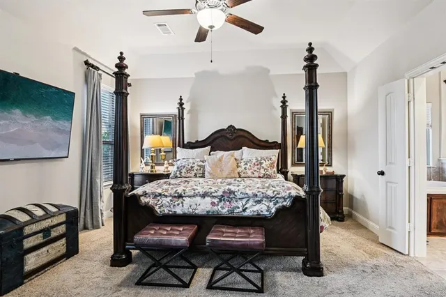 a bedroom with a bed and a television