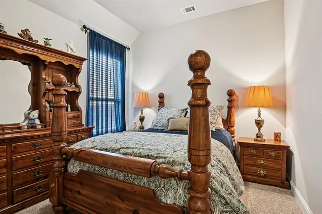 a bedroom with a bed and a mirror