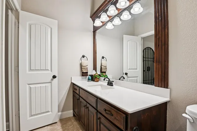 a bedroom with two beds and painting on the wall