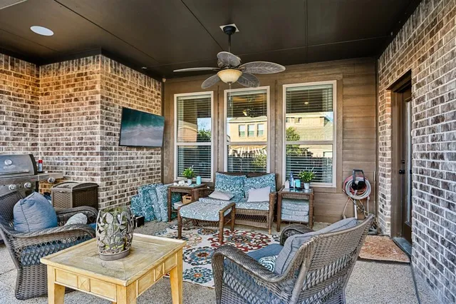 a living room with furniture and floor to ceiling windows