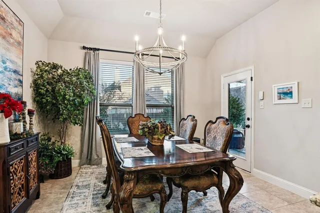 a kitchen with a table chairs sink and cabinets