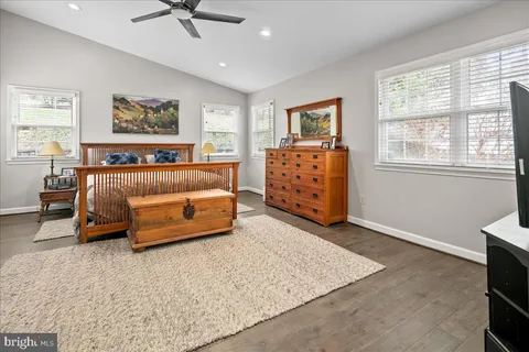 a bedroom with furniture and a rug