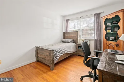 a bedroom with furniture and a window