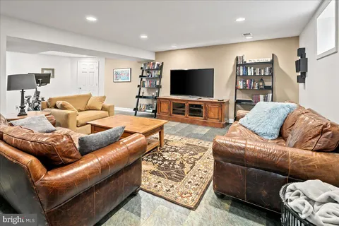 a living room with furniture and a rug
