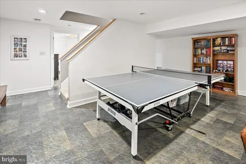 a view of a patio with couches table and chairs with wooden floor and fence