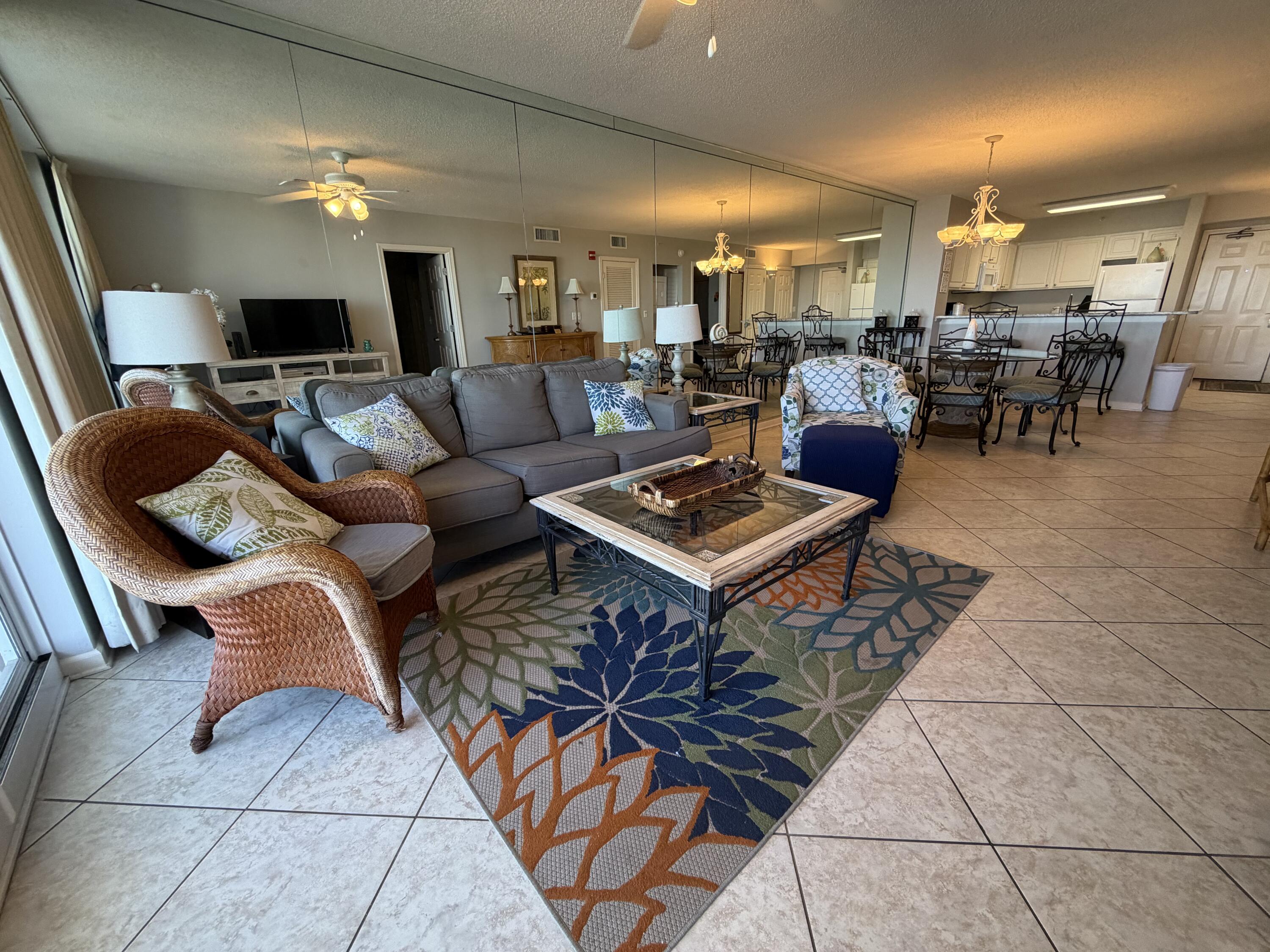 970 Highway 98, Unit 602 Destin, FL 32541 - Photo 6 of 18 a living room with lots of furniture and a dining table with wooden floor
