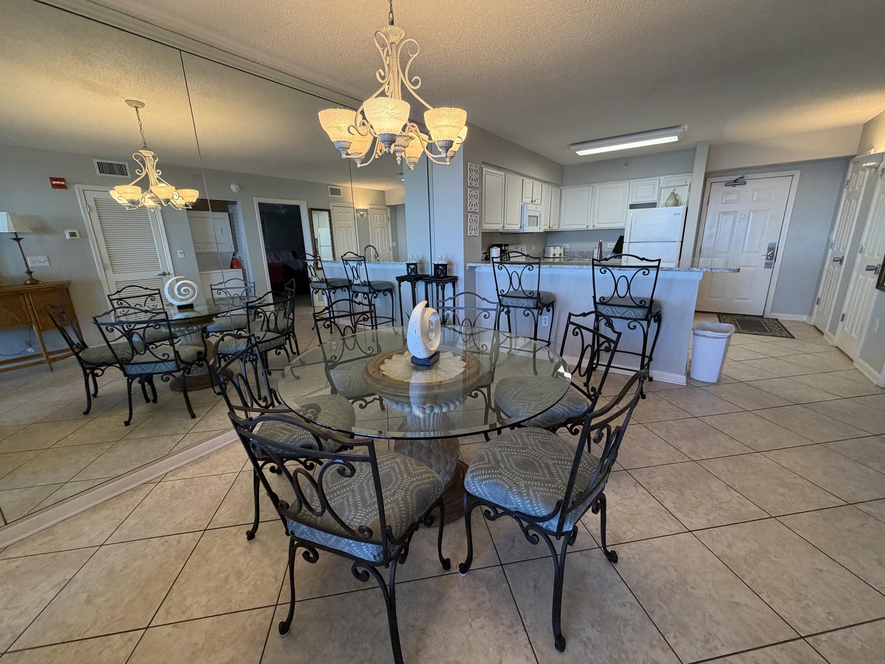 970 Highway 98, Unit 602 Destin, FL 32541 - Photo 7 of 18 a view of a dining room with furniture and chandelier