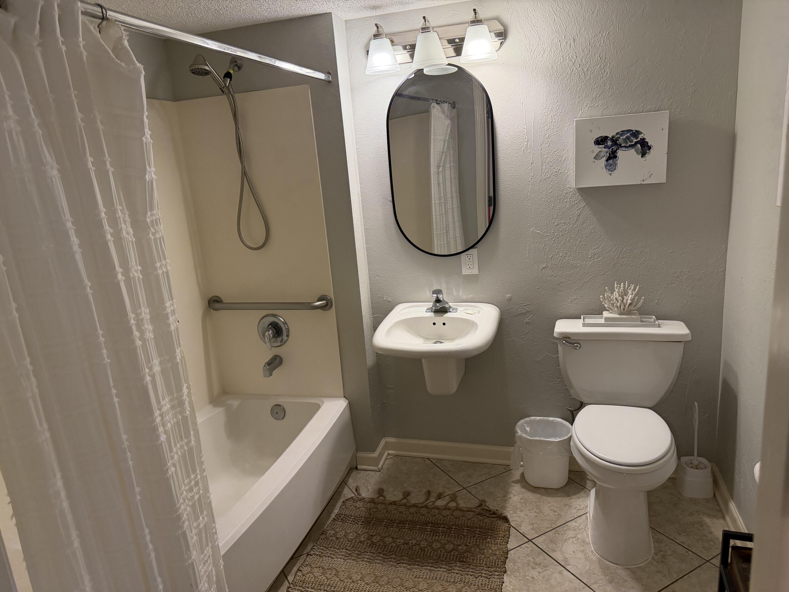 970 Highway 98, Unit 602 Destin, FL 32541 - Photo 10 of 18 a bathroom with a sink toilet and shower
