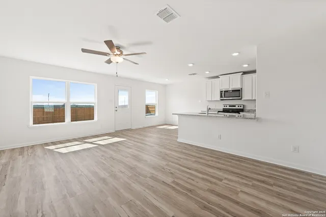 a view of kitchen with granite countertop cabinets and wooden floor