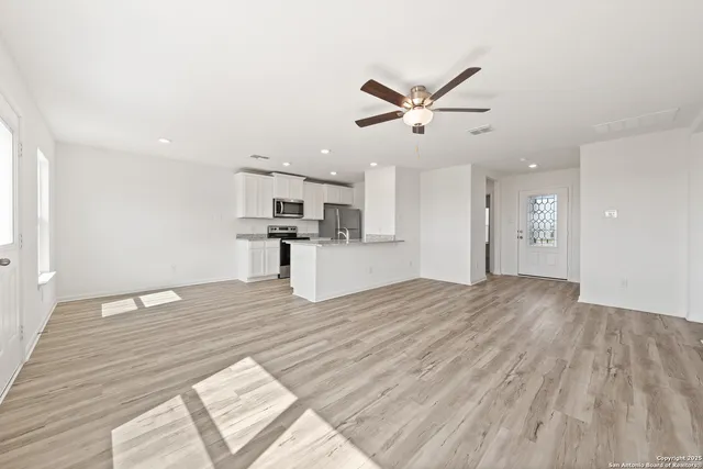 a view of a kitchen with a sink and wooden floor