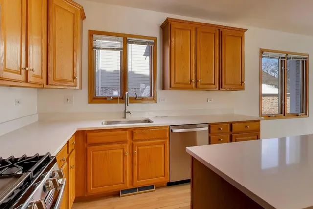 a kitchen with a sink cabinets and window