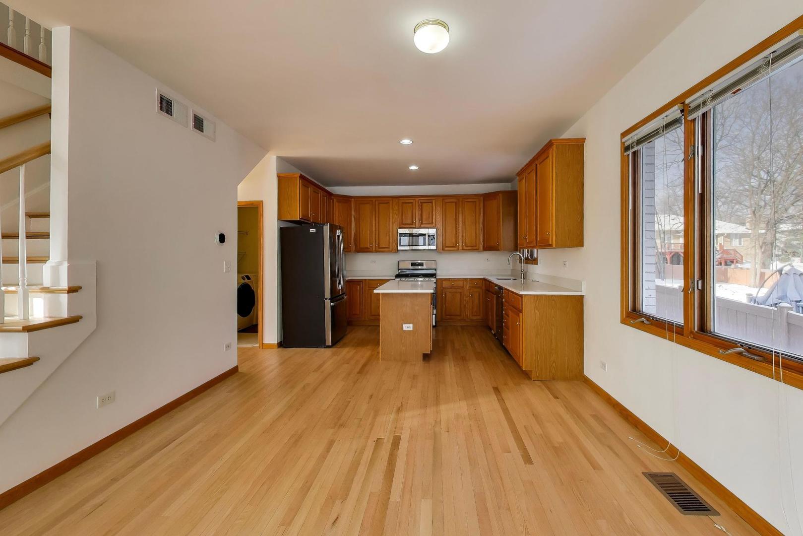 16W234 91st Street Burr Ridge, IL 60527 - Photo 14 of 50 a kitchen with stainless steel appliances granite countertop a refrigerator a sink dishwasher and a oven with wooden floor